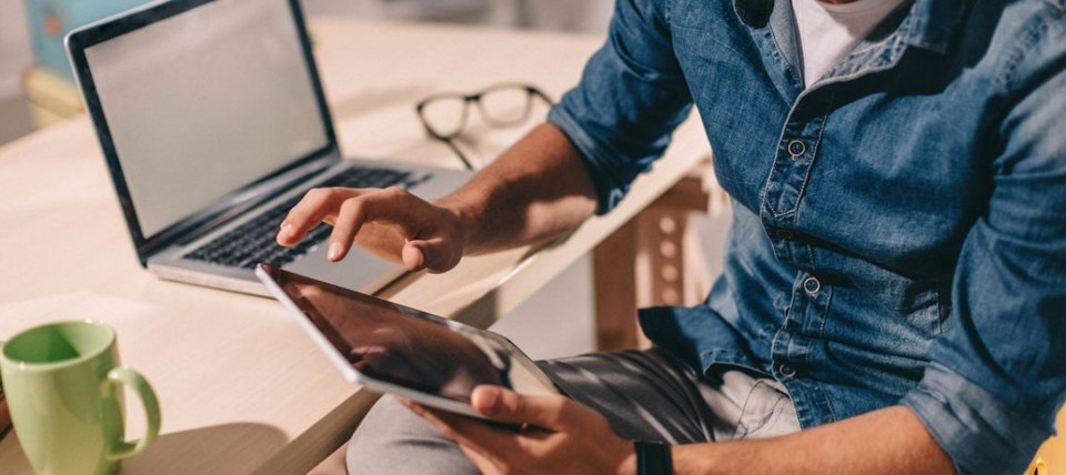 man looking at tablet