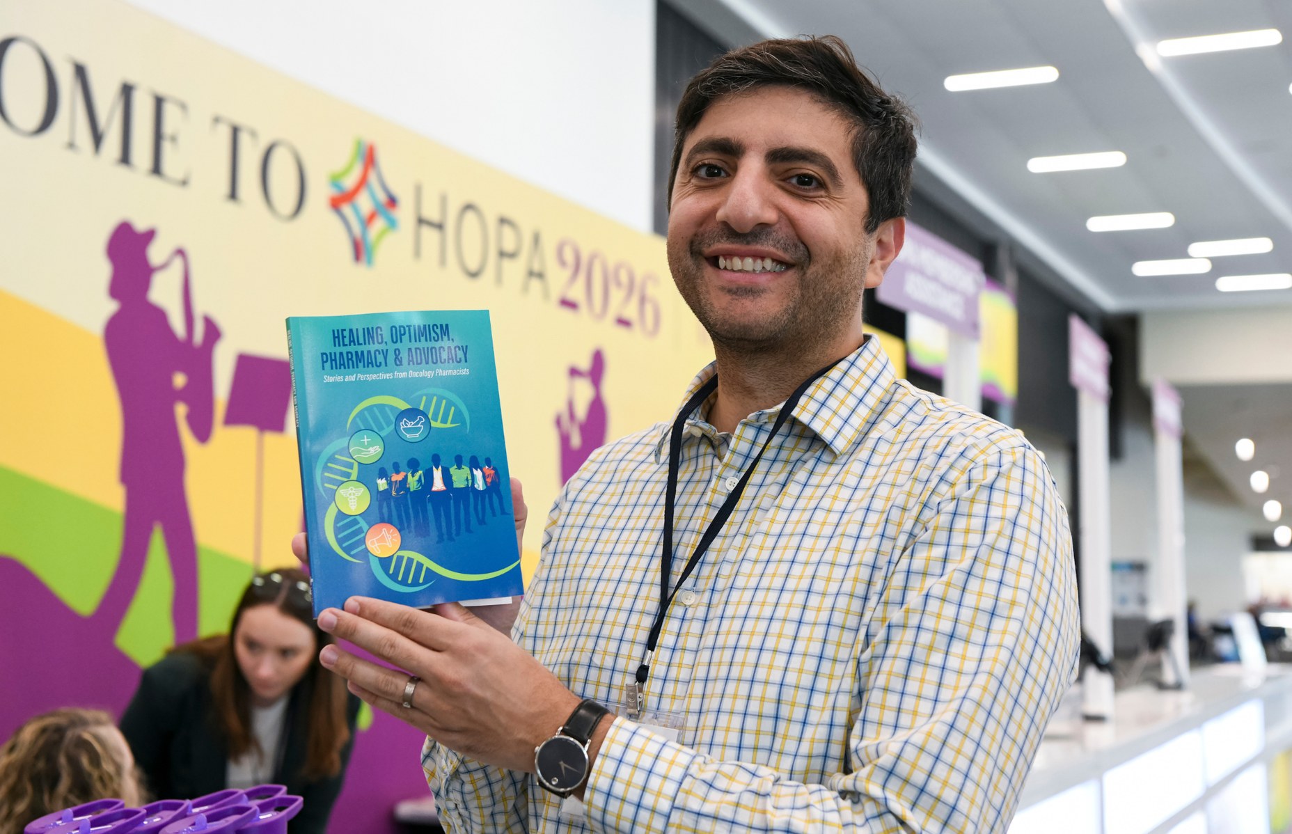 A HOPA 26 attendee holding the new HOPA book