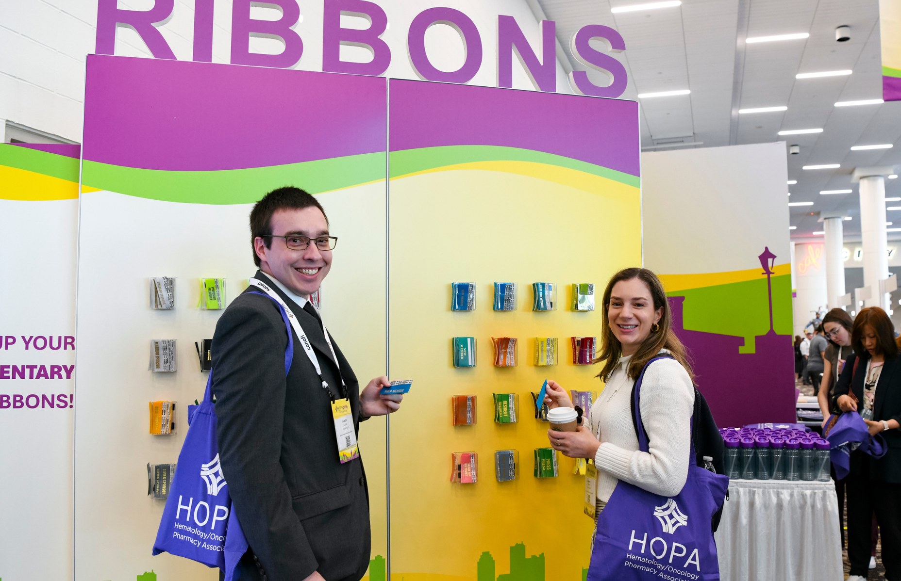 HOPA members at Annual Conference standing by the ribbons board