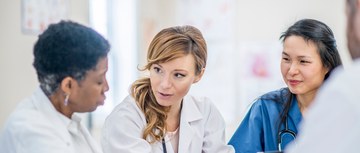A group of doctors and pharmacists and nurses talking