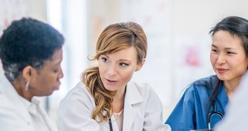 A group of doctors and pharmacists and nurses talking