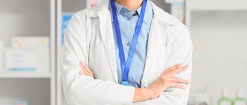 A pharmacist in a white coat