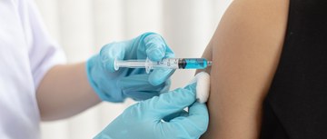 A vaccine getting injected