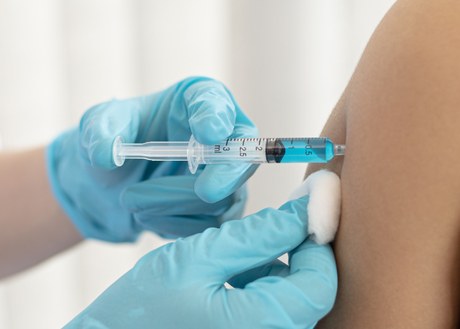 A vaccine getting injected
