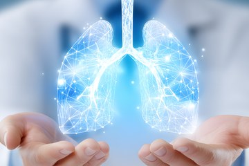 A doctor's hands holding an image of lungs