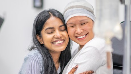 A cancer patient hugging their pharmacist