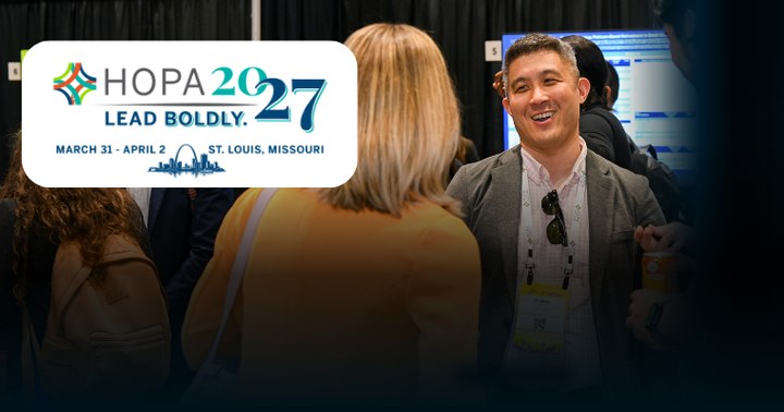 AC 2027 logo with attendees discussing research